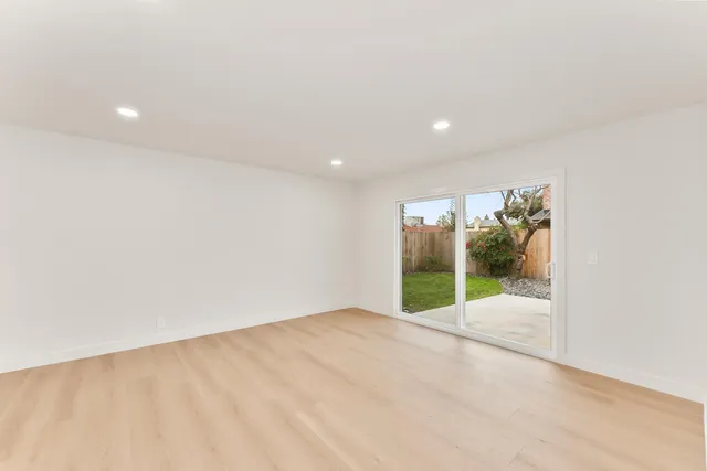 an empty room with sliding door and mountain view