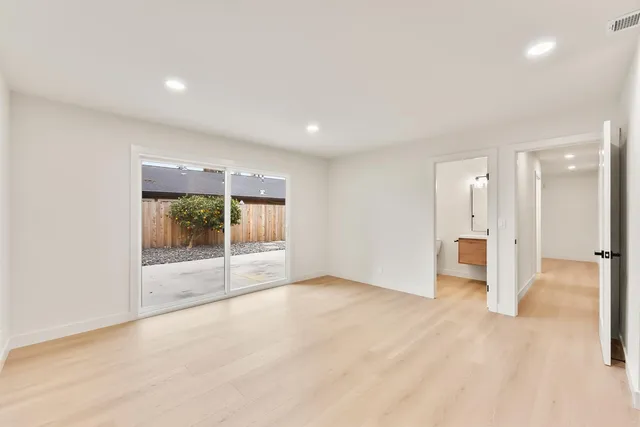 a view of a big room with a large window and front door