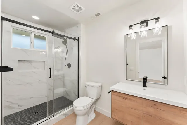 a bathroom with a toilet sink and shower