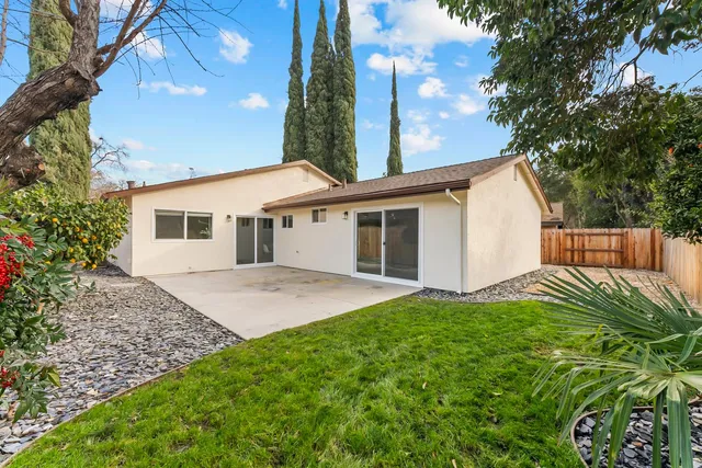 a view of a backyard with wooden fence