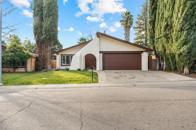 a front view of house with yard and green space