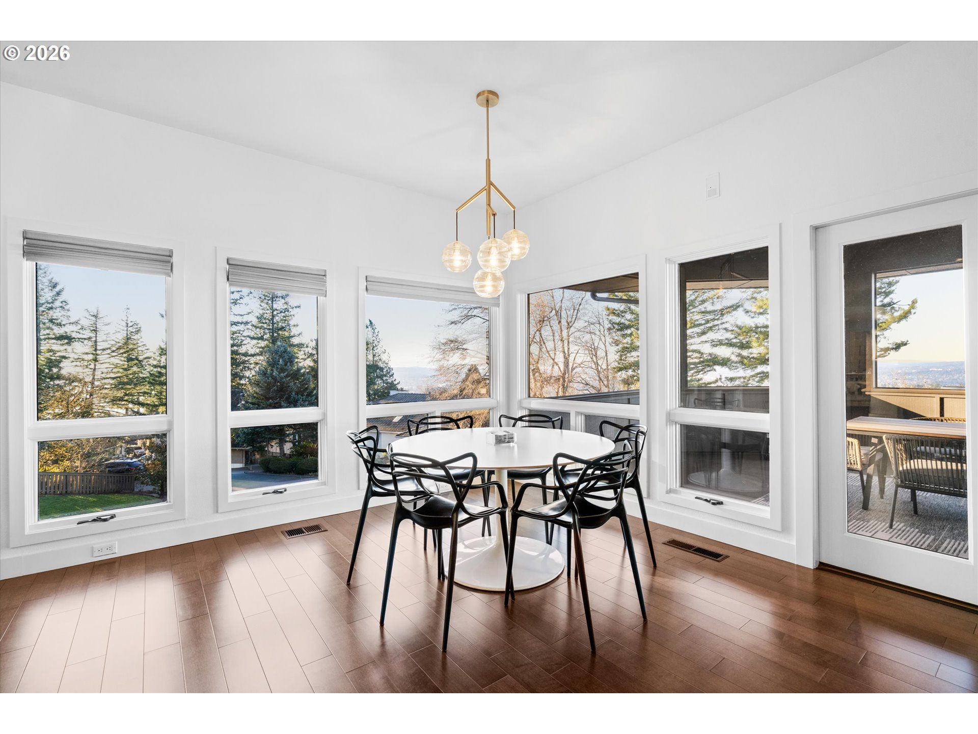 72 Nansen Summit Lake Oswego, OR 97035 - Photo 20 of 48 a dining room with wooden floor a chandelier a wooden table and chairs
