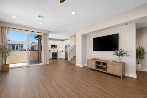 a view of a livingroom with furniture a fireplace and wooden floor