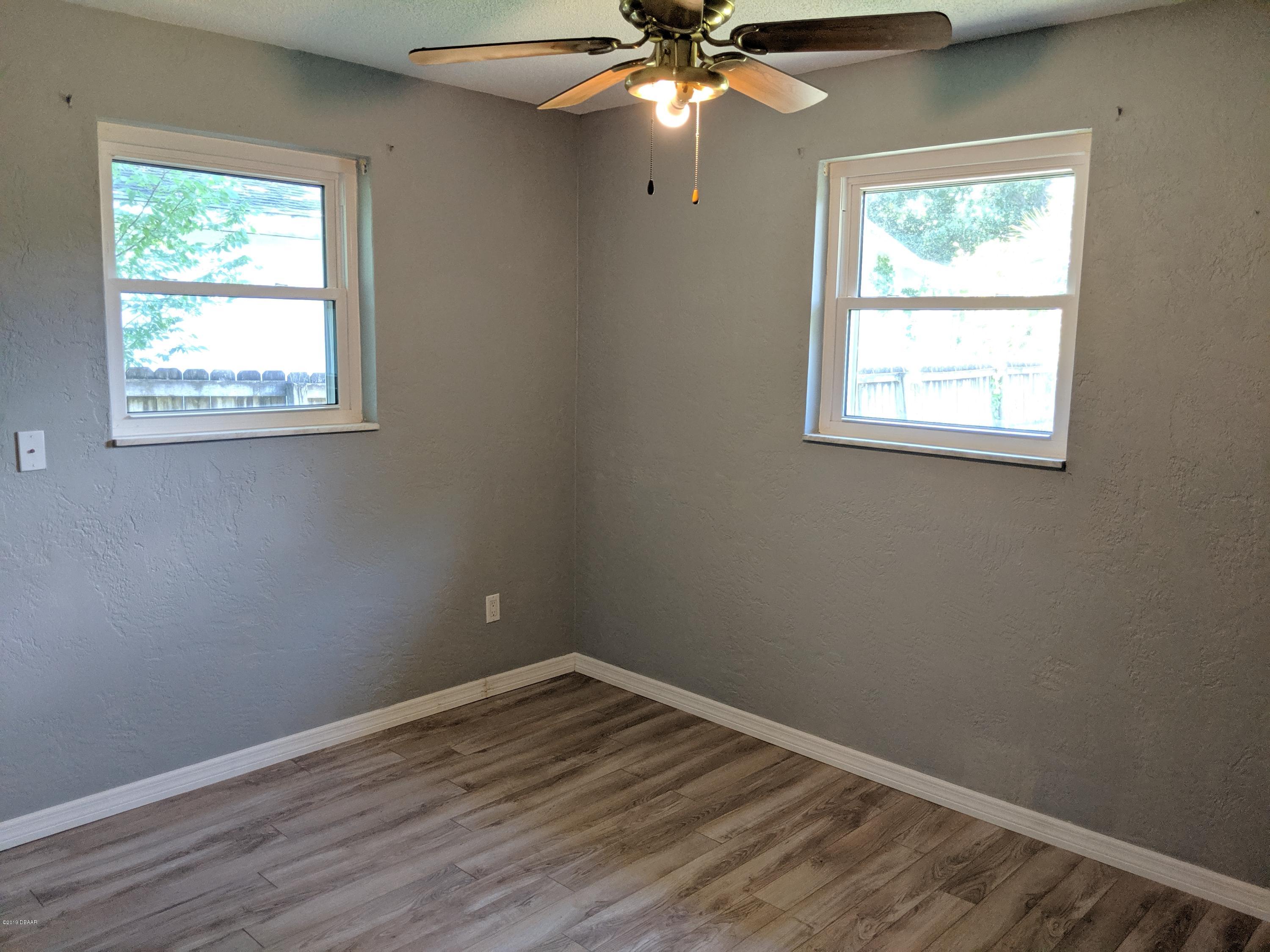 714 South Center Street Ormond Beach, FL 32174 - Photo 14 of 25 an empty room with a window