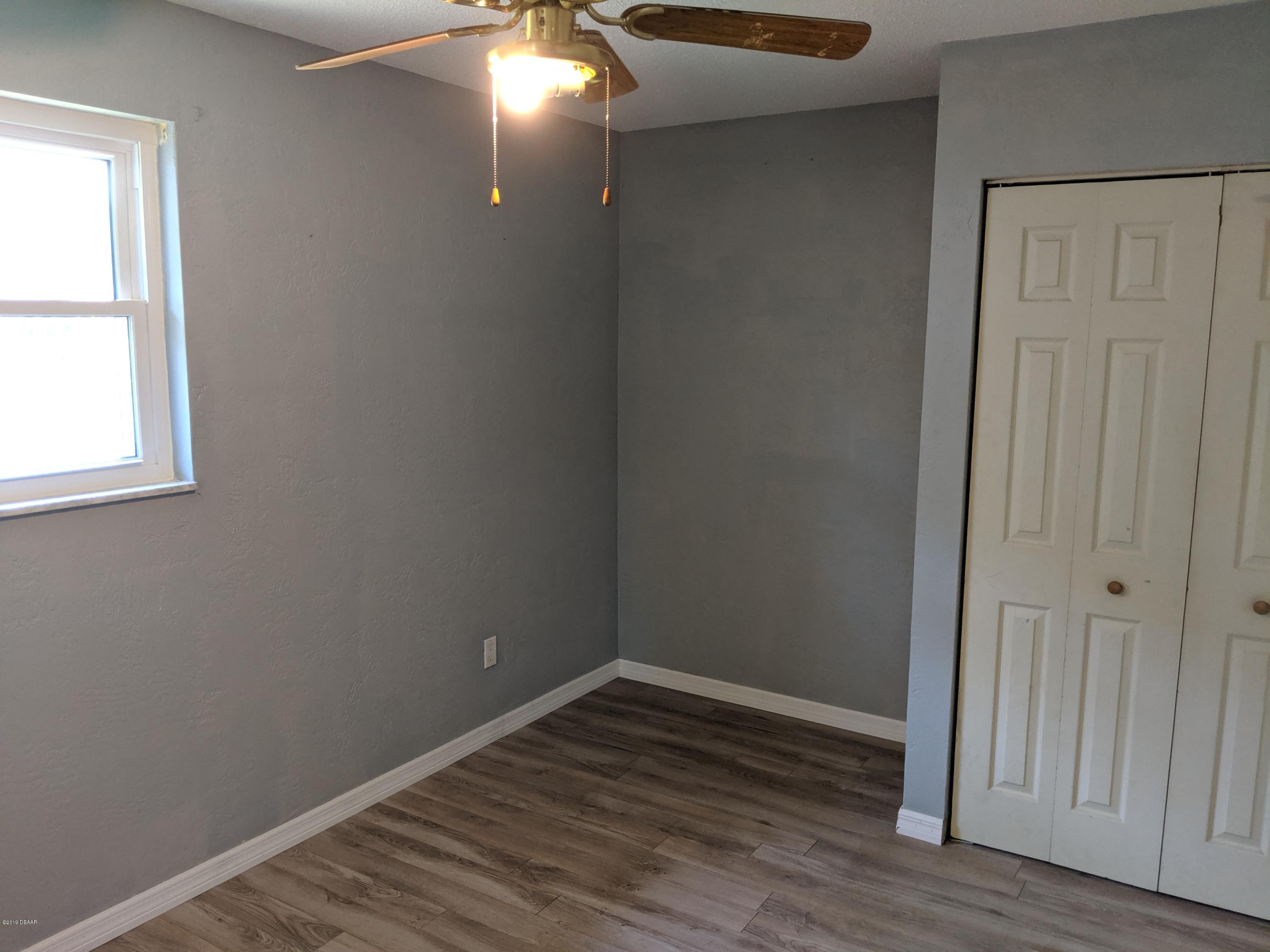 714 South Center Street Ormond Beach, FL 32174 - Photo 15 of 25 a view of an empty room with wooden floor and a window