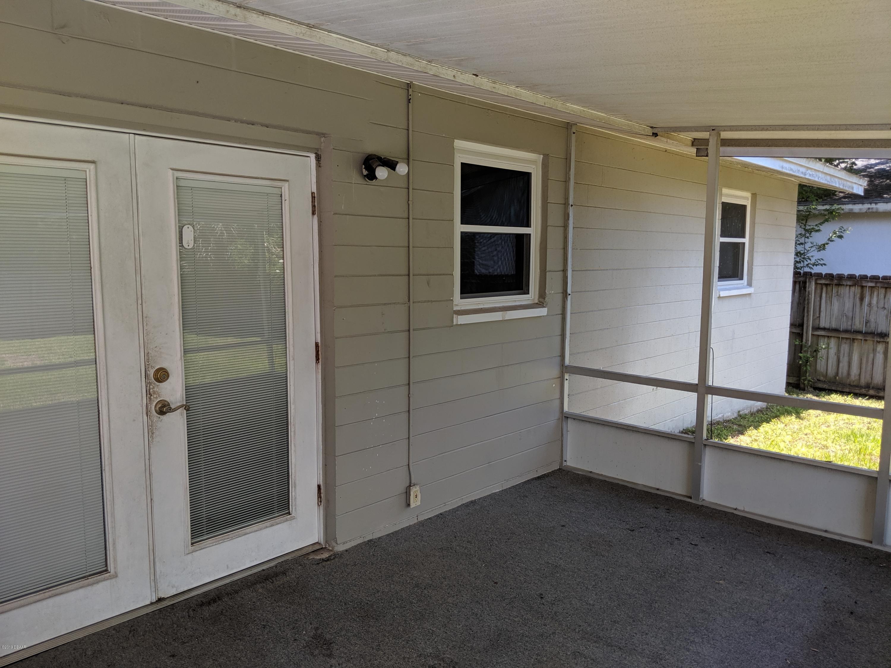 714 South Center Street Ormond Beach, FL 32174 - Photo 22 of 25 a view of an empty room and a windows