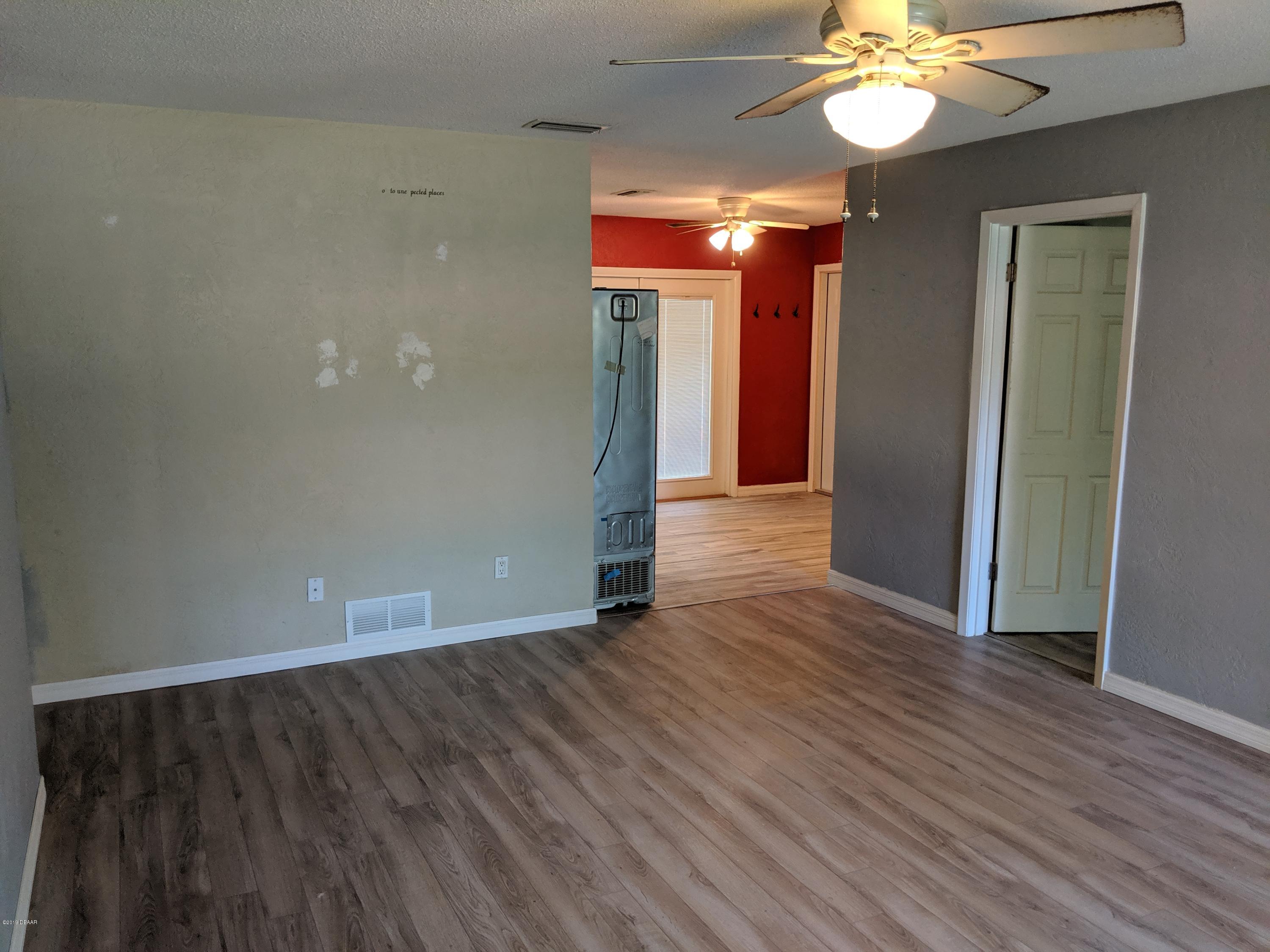 714 South Center Street Ormond Beach, FL 32174 - Photo 7 of 25 a view of an empty room with wooden floor and a window