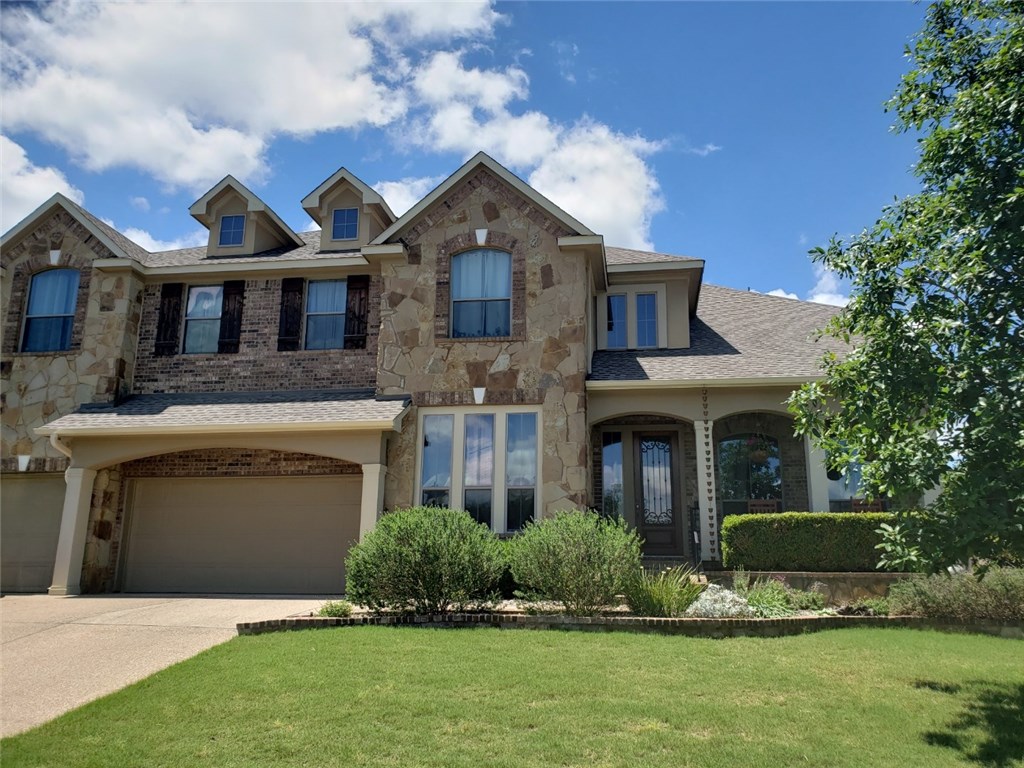 409 Blazing Star Drive Austin, TX 78737 - Photo 1 of 1 a front view of a house with a yard and garage