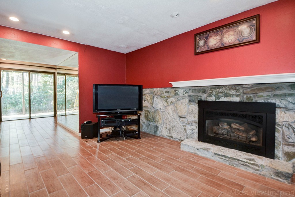 2 Linwood Road Framingham, MA 01702 - Photo 23 of 28 a living room with furniture a flat screen tv and a fireplace
