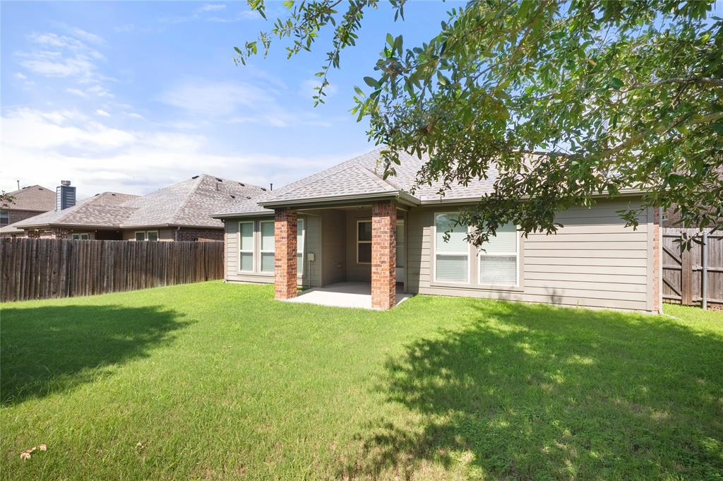 520 Rustic Oak Lane McKinney, TX 75072 - Photo 27 of 30 Expansive green lawn featuring a covered patio with brick columns, siding exterior, and a wood privacy fence