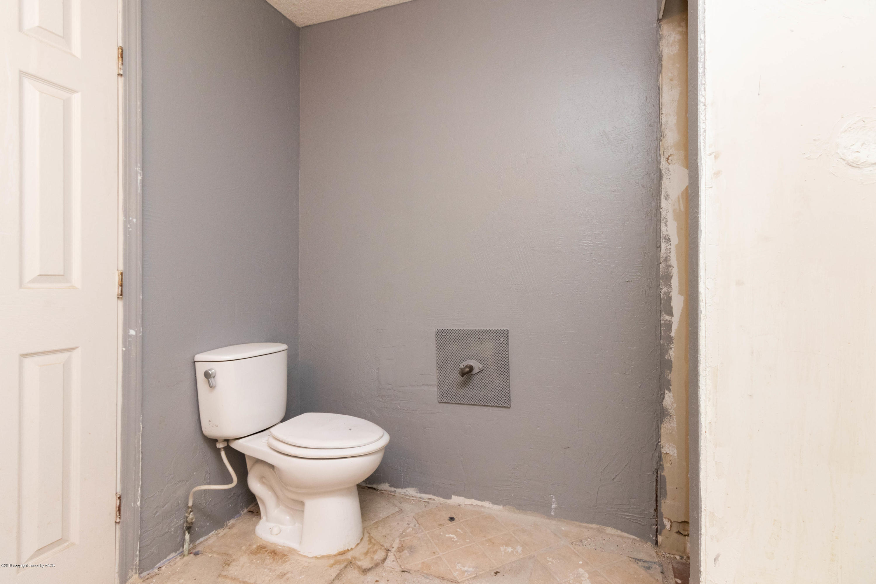 4002 South Harrison Street Amarillo, TX 79110 - Photo 17 of 21 a white toilet sitting next to a white cabinet