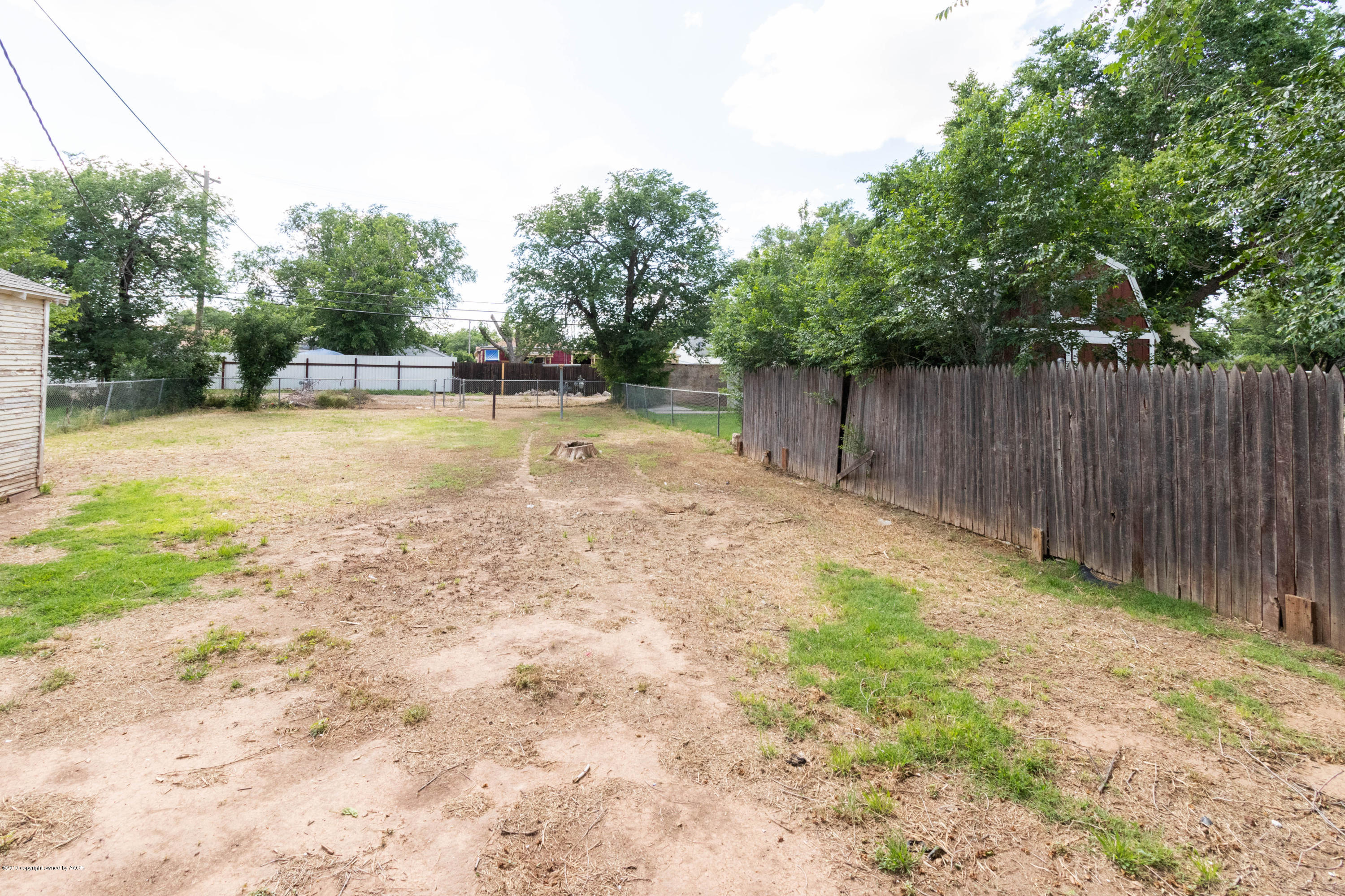 4002 South Harrison Street Amarillo, TX 79110 - Photo 19 of 21 a view of a backyard with wooden fence