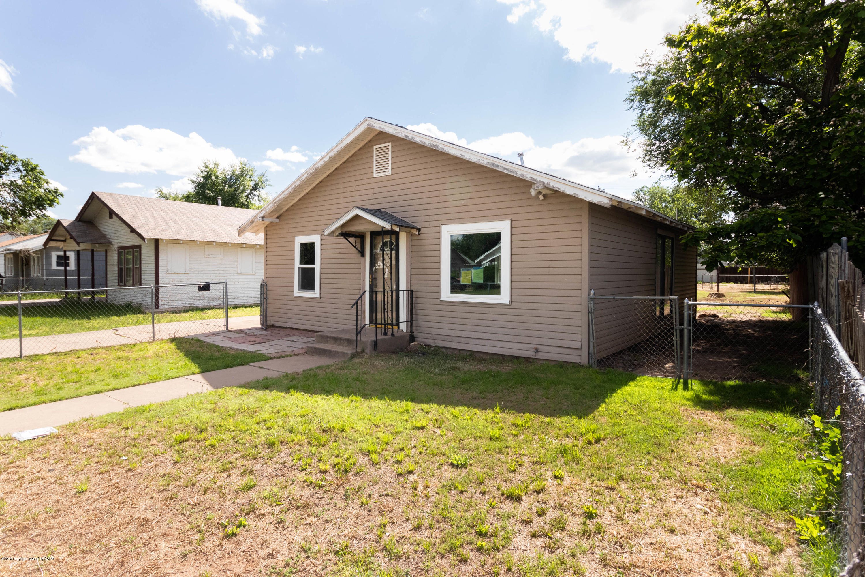 4002 South Harrison Street Amarillo, TX 79110 - Photo 2 of 21 a view of a house with swimming pool and a yard