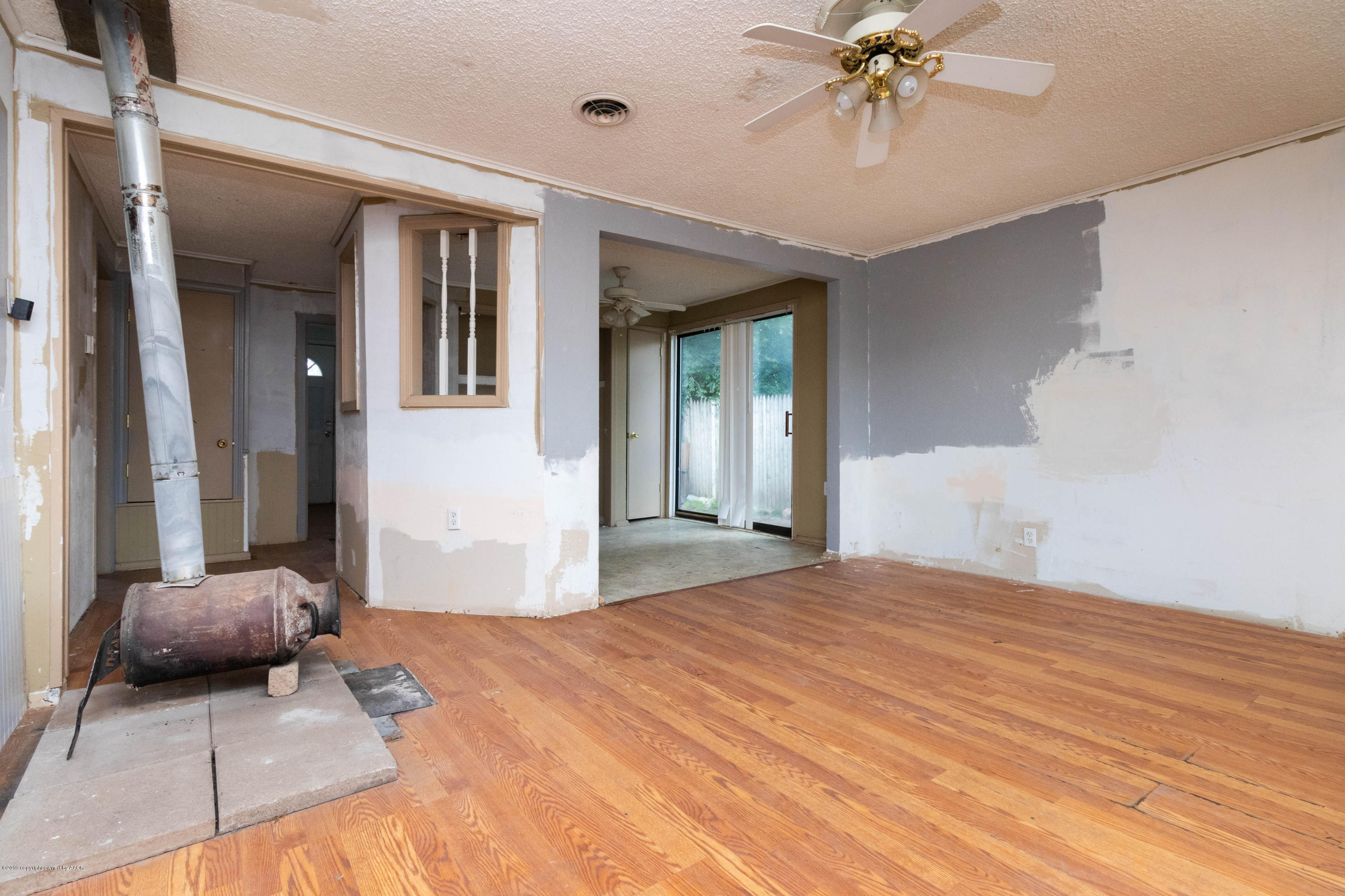 4002 South Harrison Street Amarillo, TX 79110 - Photo 5 of 21 a bedroom with a bed and a chandelier