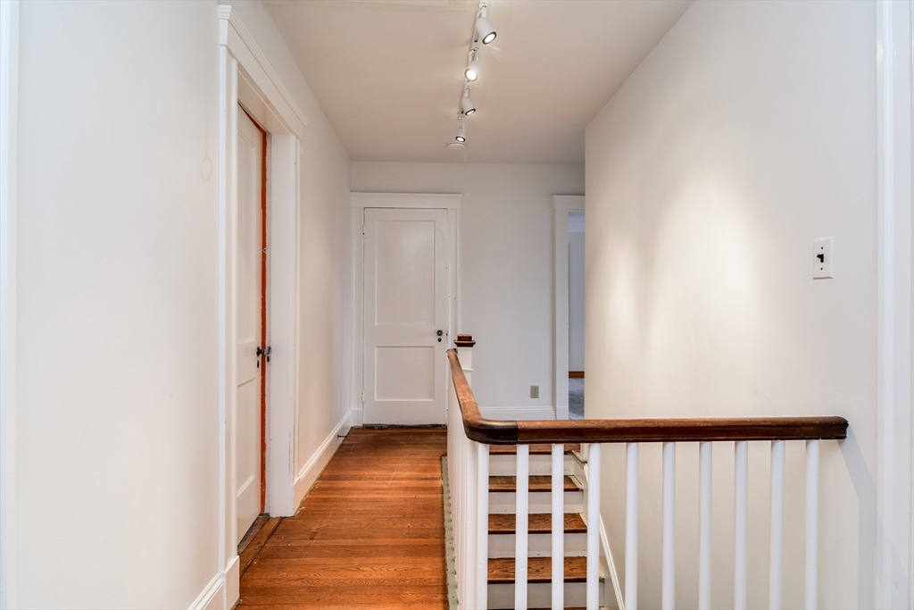 85 Barber Road Framingham, MA 01702 - Photo 15 of 30 a view of a hallway with wooden floor and staircase