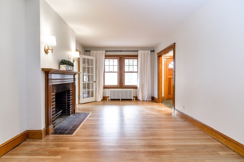 85 Barber Road Framingham, MA 01702 - Photo 4 of 30 a view of a livingroom with wooden floor and a fireplace