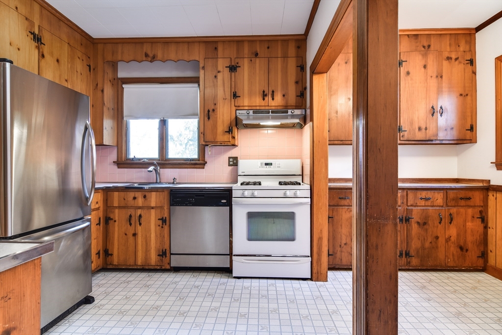 85 Barber Road Framingham, MA 01702 - Photo 8 of 30 a kitchen with stainless steel appliances granite countertop a refrigerator a stove and a sink with wooden floors
