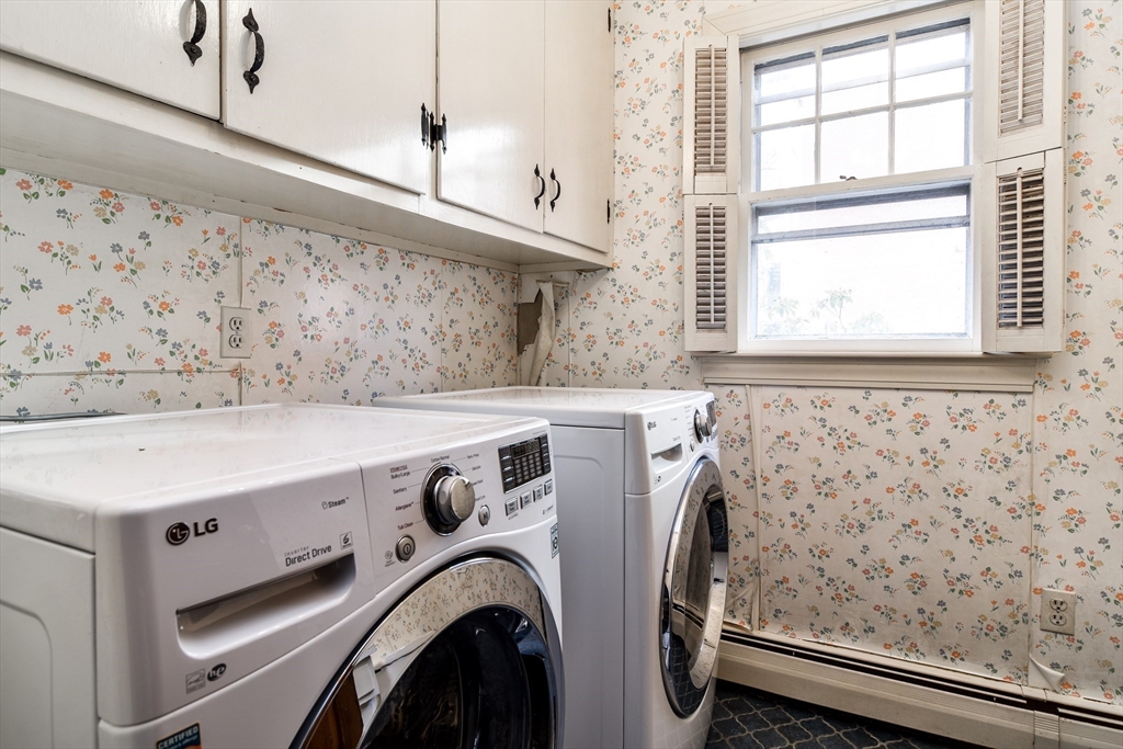85 Barber Road Framingham, MA 01702 - Photo 10 of 30 a view of washer and dryer with kitchen in the background