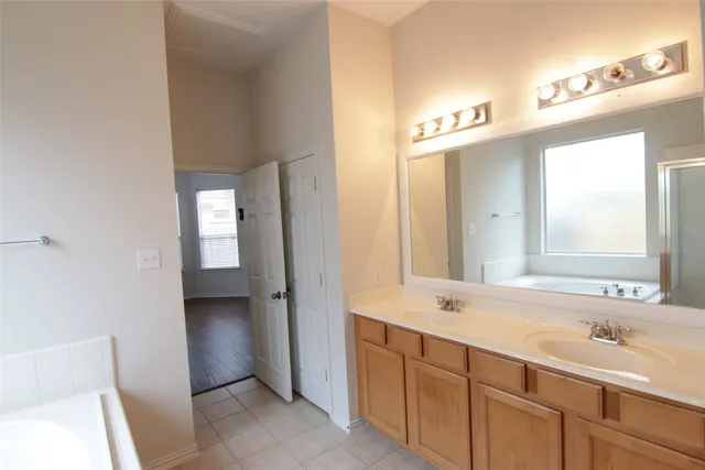 a bathroom with a double vanity sink and mirror