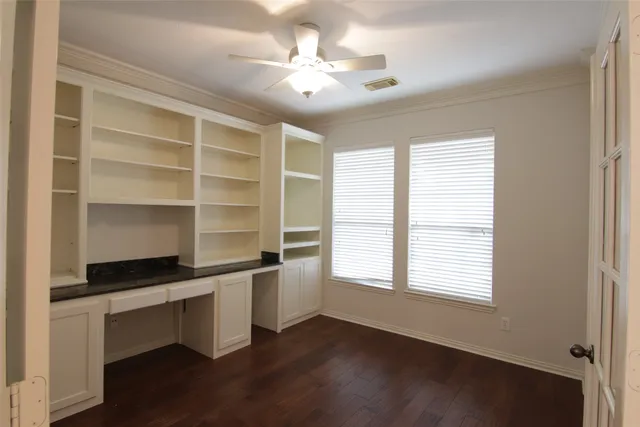 a workspace with windows and white walls