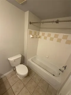 a bathroom with a toilet and shower