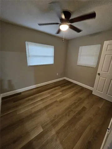 a view of room with window and ceiling fan