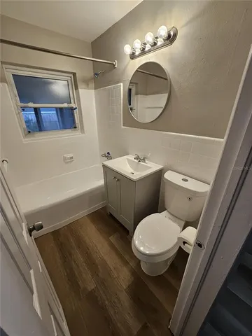 a bathroom with a toilet a sink and bathtub