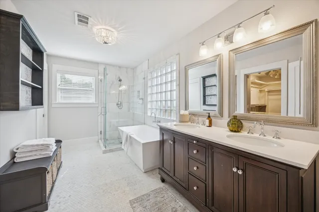 a large spacious bathroom with a large tub shower and sink