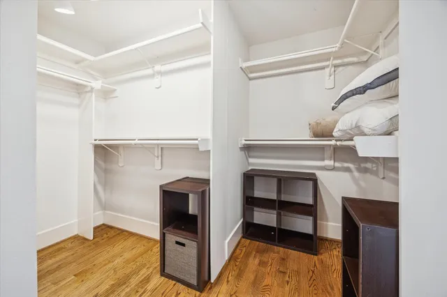 a spacious bathroom with a double vanity sink a large mirror and a bathtub