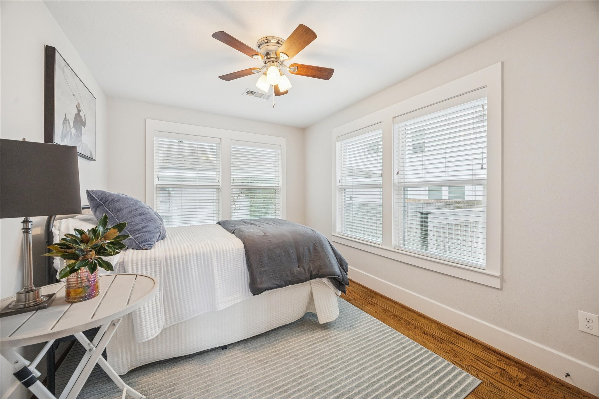 4605 Fisk Street Houston, TX 77009 - Photo 13 of 22 a bedroom with a bed painting on wall and a large window