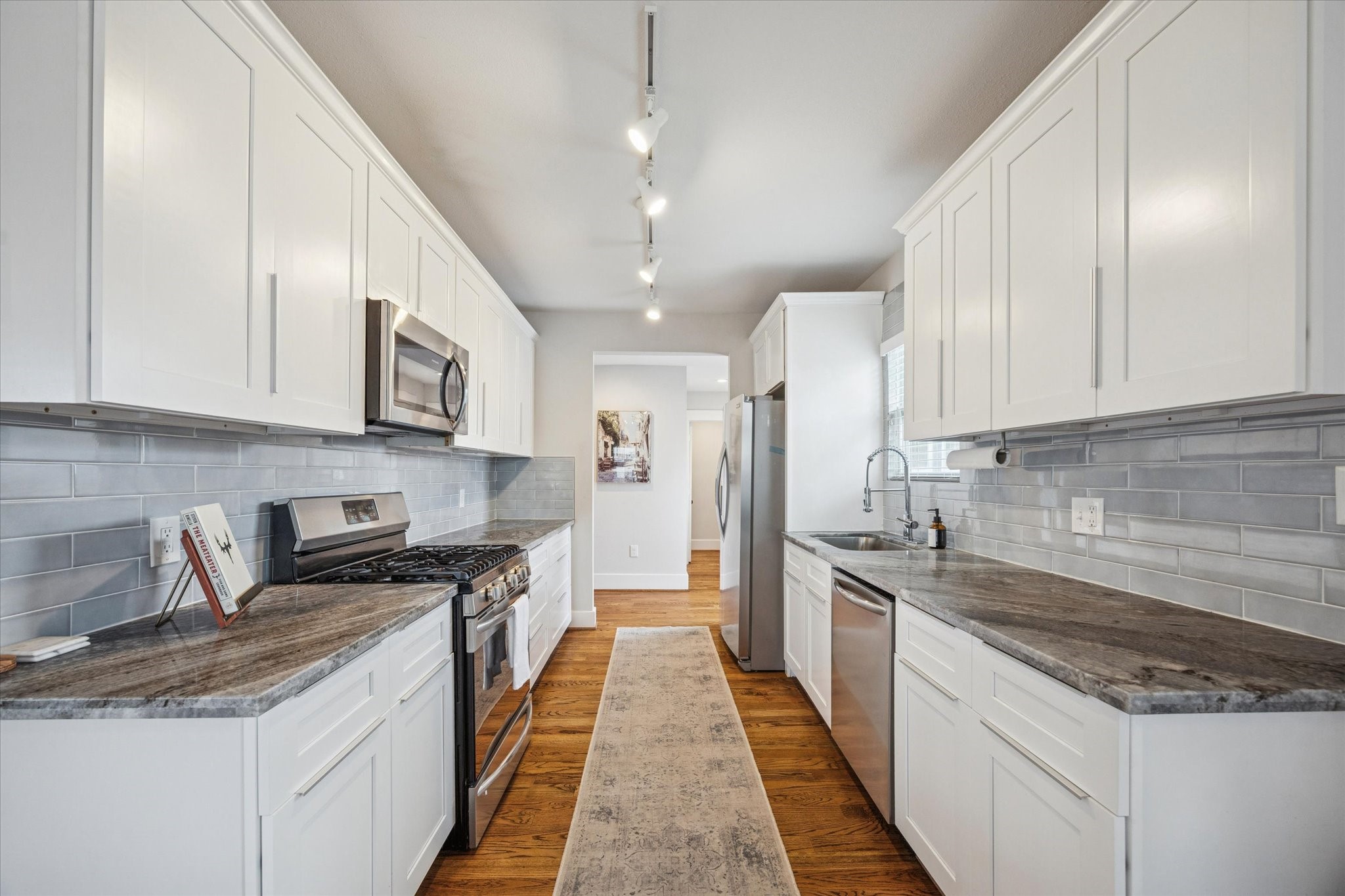 4605 Fisk Street Houston, TX 77009 - Photo 8 of 22 a large kitchen with stainless steel appliances granite countertop a stove a sink and a white cabinets