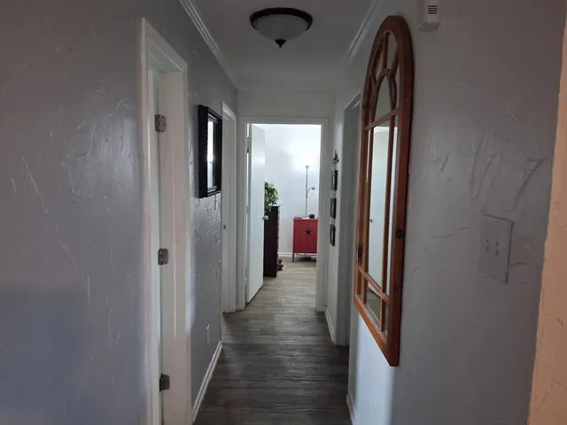 a view of hallway with wooden floor