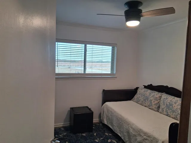 a bedroom with a bed and a potted plant