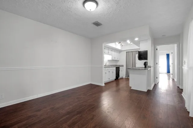a kitchen with granite countertop a sink stainless steel appliances and cabinets