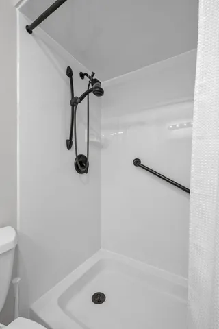 a view of a hallway with wooden floor and a window