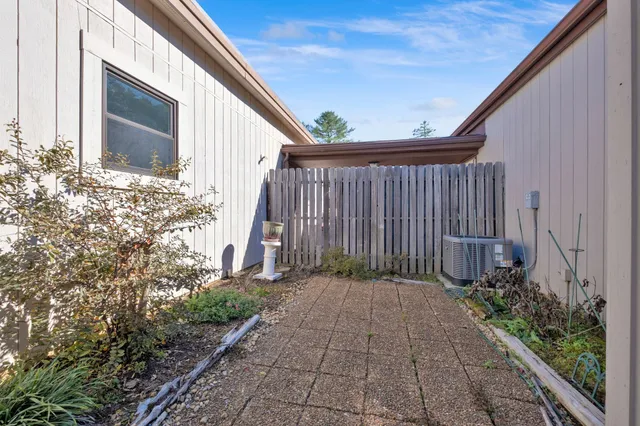 a wooden bench sitting in front of a building