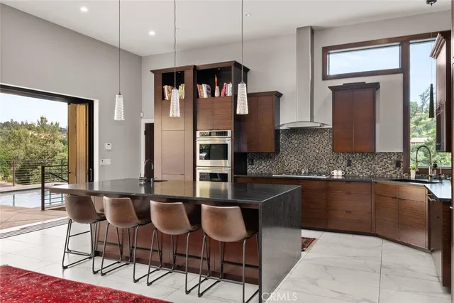 a living room with furniture a flat screen tv and kitchen view