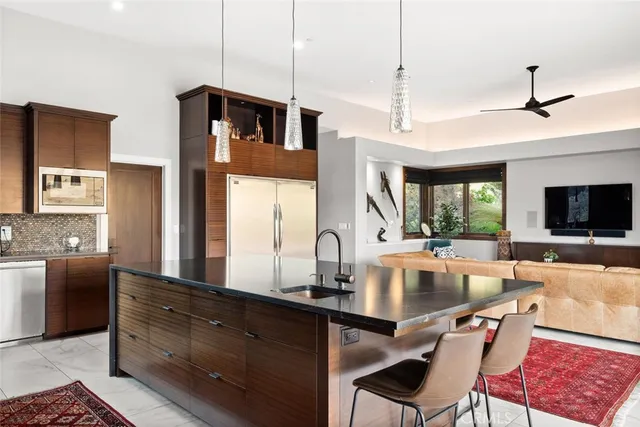 a kitchen with stainless steel appliances granite countertop a refrigerator and a sink