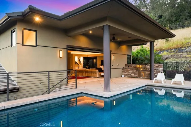 a backyard of a house with table and chairs