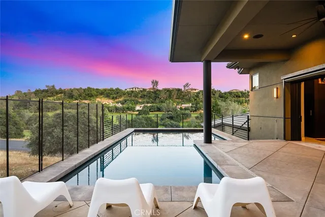 a view of a chairs and table in the balcony