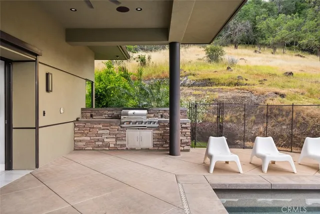 a swimming pool with outdoor seating and yard