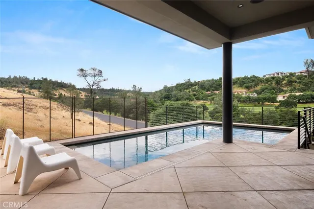 a view of a house with pool and garden