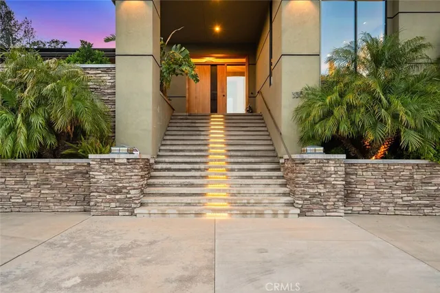 a view of a hallway with furniture and a window