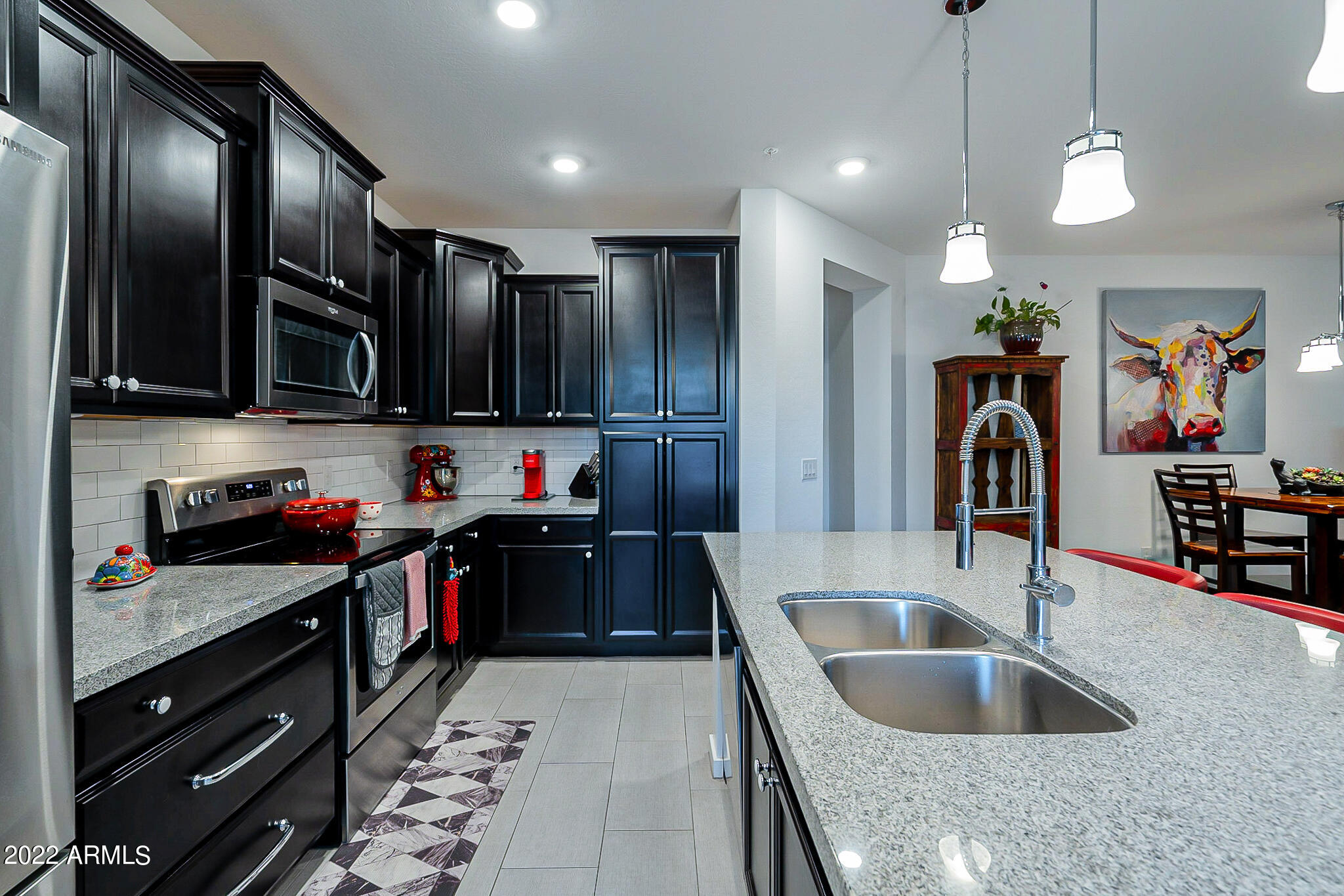3900 East Baseline Road, Unit 142 Phoenix, AZ 85042 - Photo 8 of 28 a kitchen with kitchen island granite countertop a sink stainless steel appliances and cabinets