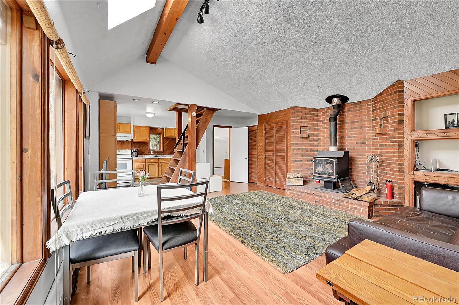 101 Campbell Road Bailey, CO 80421 - Photo 14 of 49 a bedroom with furniture and a fireplace