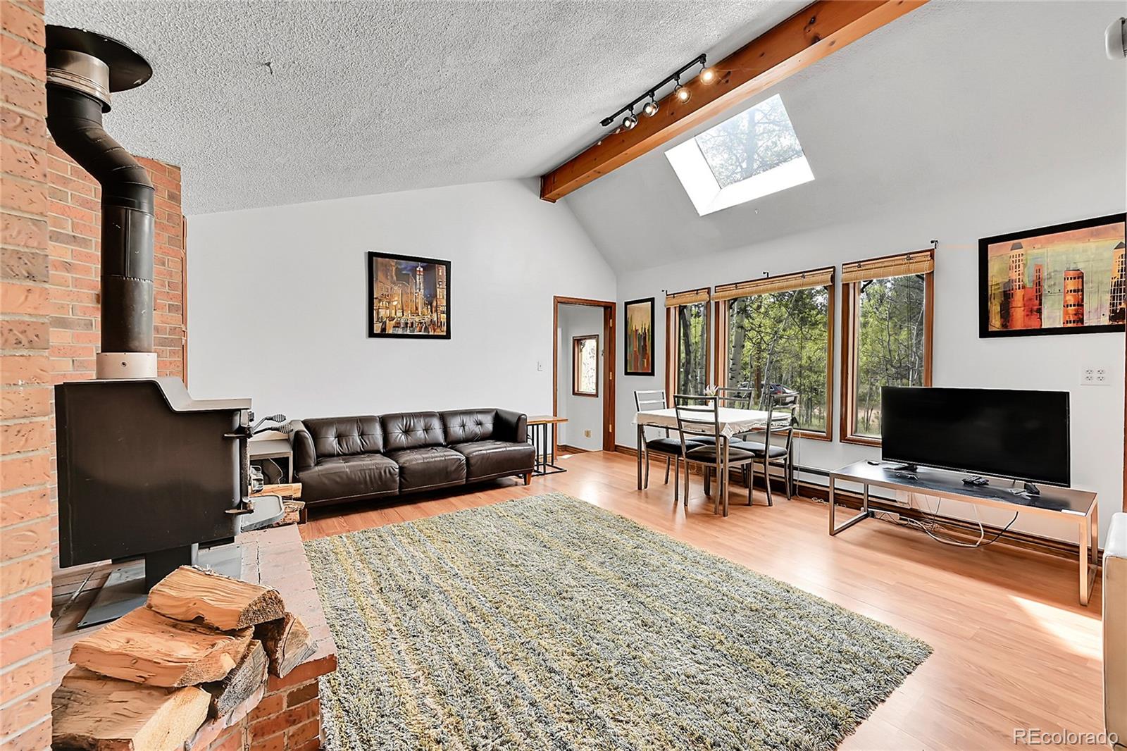 101 Campbell Road Bailey, CO 80421 - Photo 15 of 49 a living room with furniture a flat screen tv and a floor to ceiling window