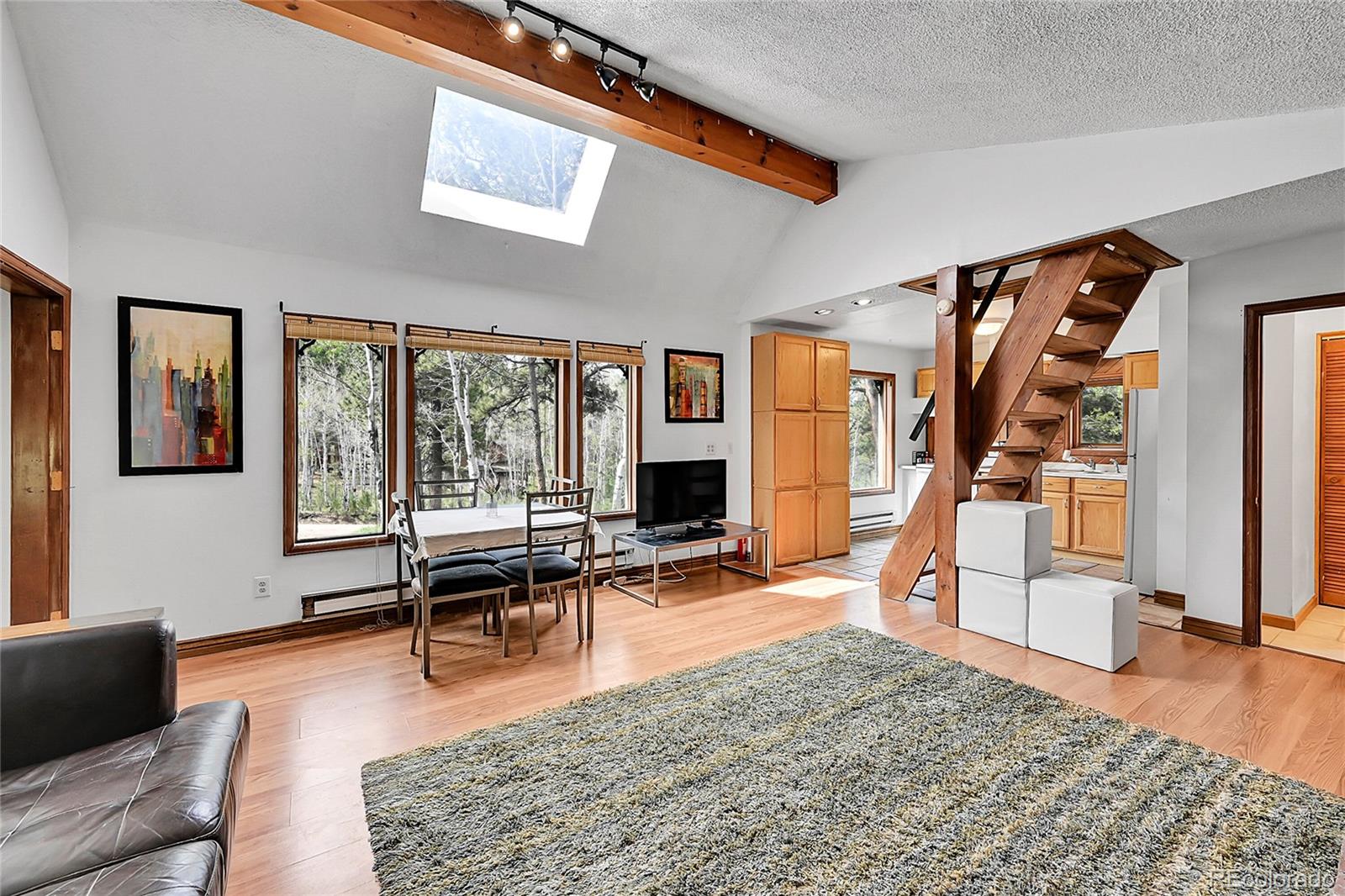 101 Campbell Road Bailey, CO 80421 - Photo 17 of 49 a living room with furniture wooden floor and a large window