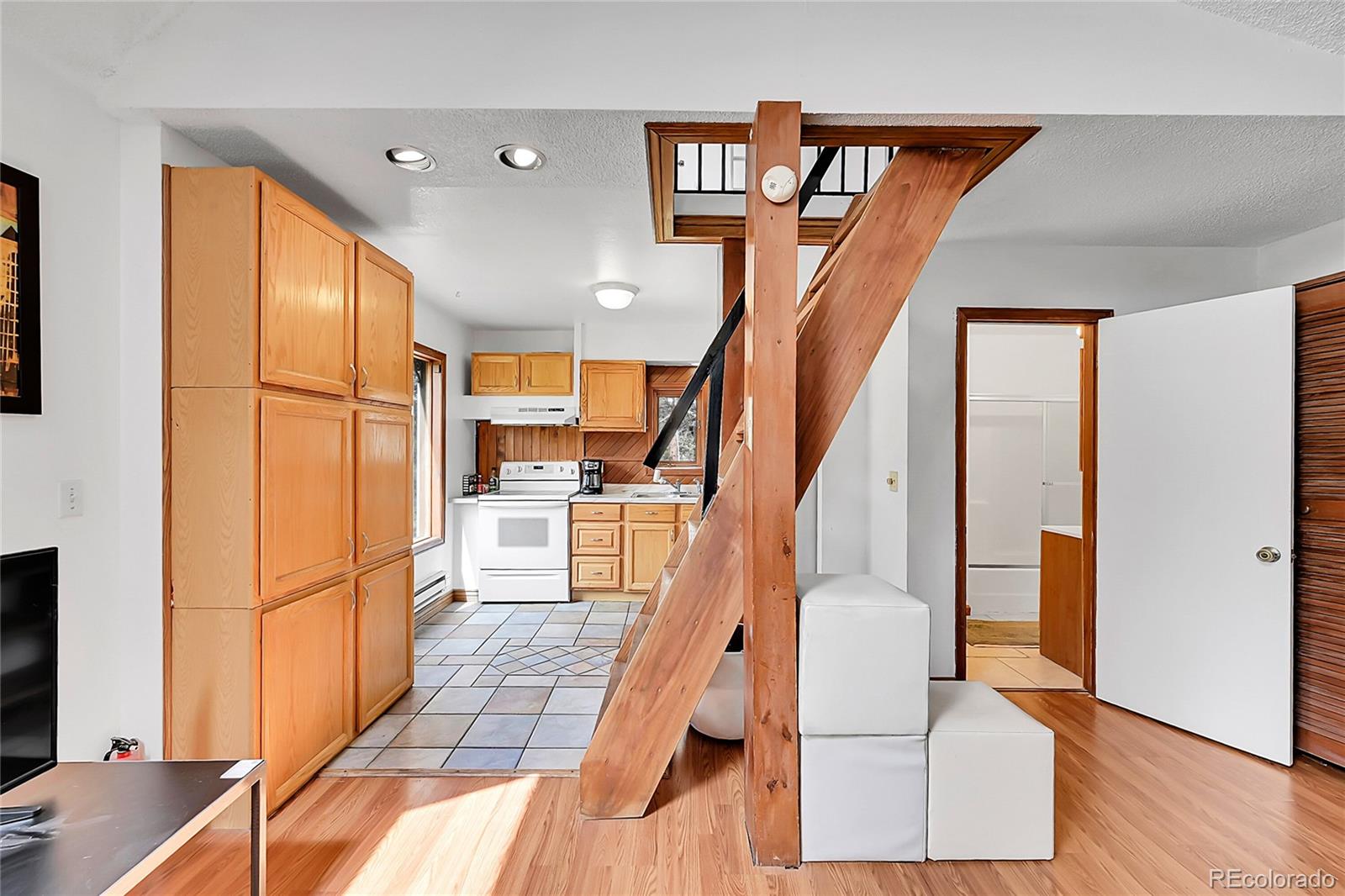 101 Campbell Road Bailey, CO 80421 - Photo 19 of 49 a view of entryway and hall with wooden floor