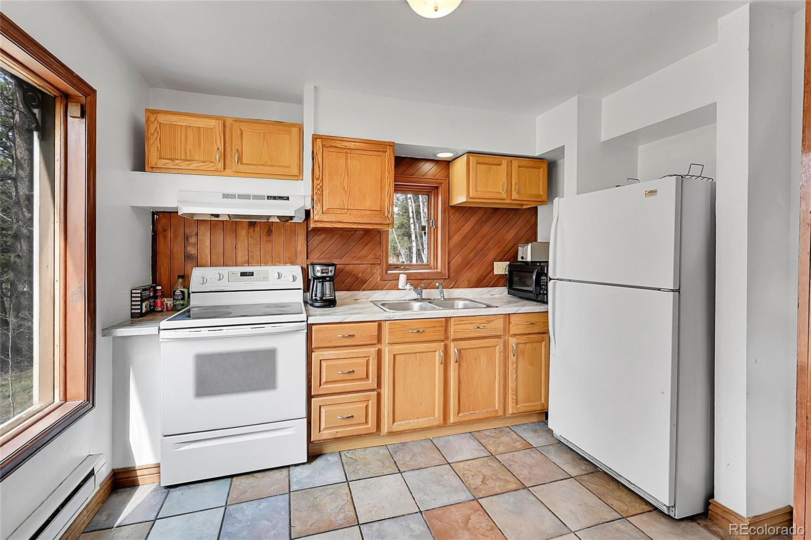 101 Campbell Road Bailey, CO 80421 - Photo 20 of 49 a kitchen with appliances cabinets and furniture