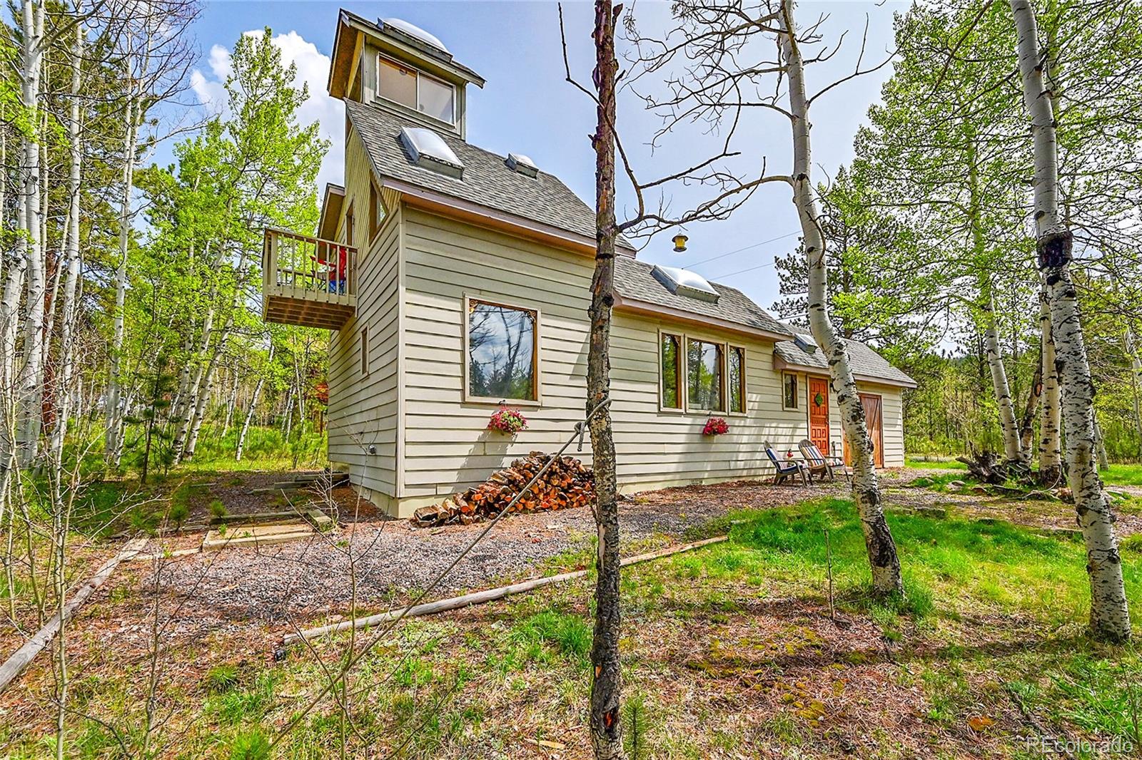 101 Campbell Road Bailey, CO 80421 - Photo 2 of 49 a view of a house with a yard